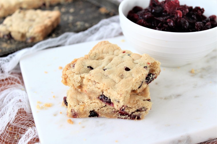 Gluten Free Cranberry White Chocolate Cookie Bars- The Gluten Free Gathering - easy to make, in one sheet pan, these cookies are festive and delicious. #glutenfree #glutenfreecookies #christmascookies #glutenfreechristmas #glutenfreechristmascookies #barcookies #whitechocolaterecipes #cranberryrecipes